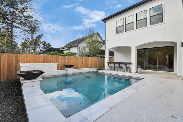 view of pool with a patio area and an outdoor bar