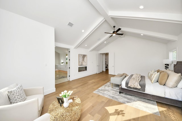 living room with vaulted ceiling with beams, light hardwood / wood-style flooring, and ceiling fan