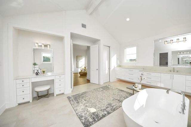 bathroom featuring vanity, a bath, vaulted ceiling with beams, and a healthy amount of sunlight