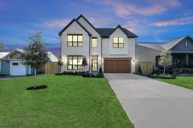 view of front of home featuring a garage and a yard