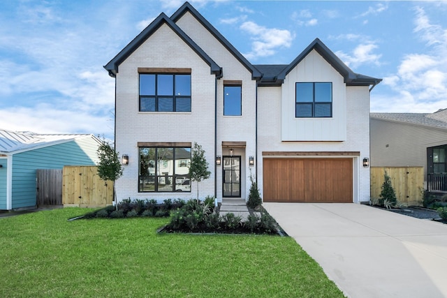 view of front of property featuring a garage and a front lawn