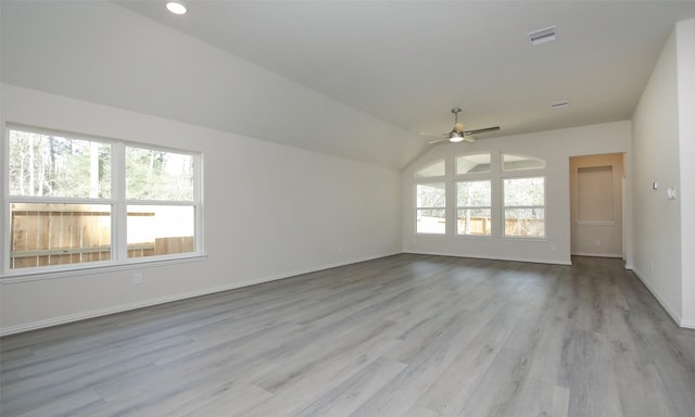 empty room featuring light wood-type flooring, vaulted ceiling, and ceiling fan