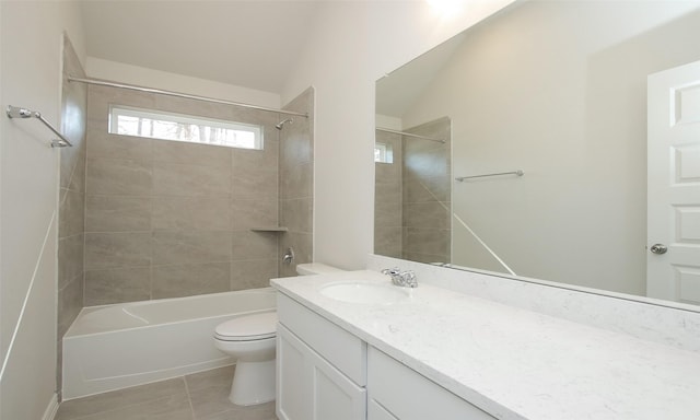 full bathroom with tile patterned floors, vanity, vaulted ceiling, toilet, and tiled shower / bath