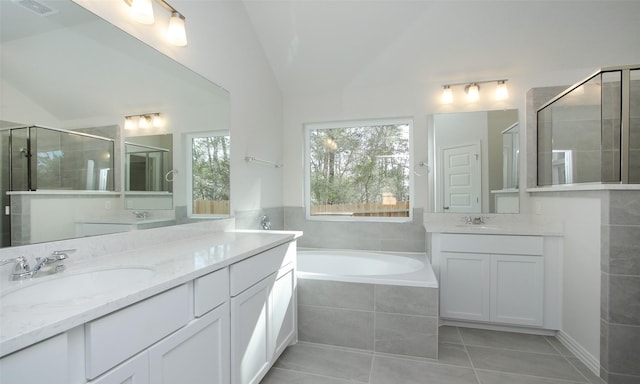 bathroom with vanity, tile patterned flooring, plus walk in shower, and vaulted ceiling