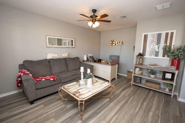 living room featuring ceiling fan and hardwood / wood-style floors