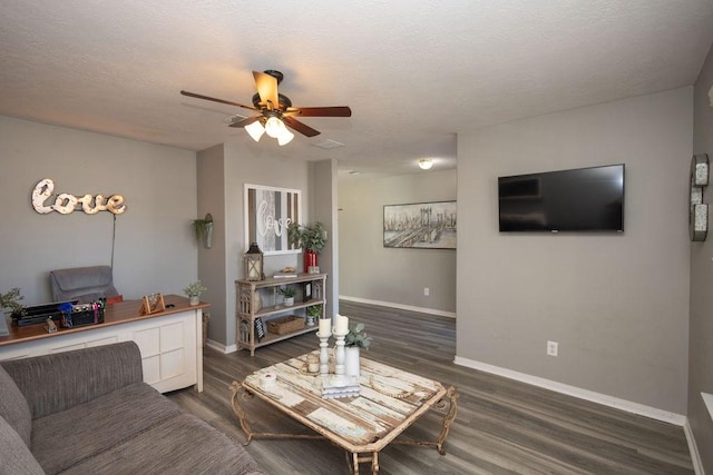 living room featuring a textured ceiling, dark hardwood / wood-style flooring, and ceiling fan