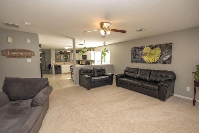 carpeted living room with ceiling fan