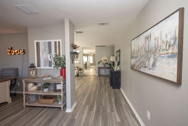 hall featuring hardwood / wood-style flooring and a textured ceiling