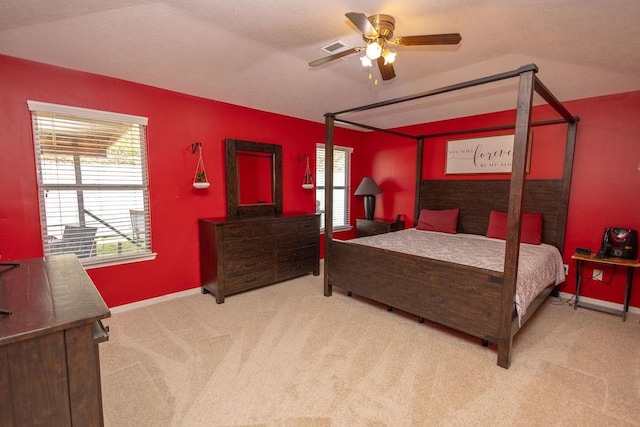 bedroom featuring ceiling fan, light carpet, and vaulted ceiling