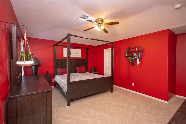 bedroom featuring a textured ceiling, ceiling fan, lofted ceiling, and carpet floors