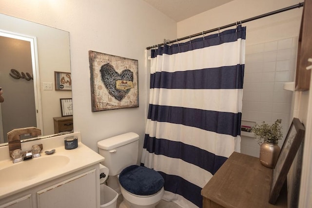 bathroom with vanity, toilet, and curtained shower