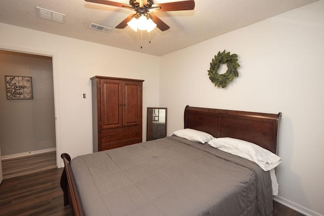 bedroom with ceiling fan and dark hardwood / wood-style floors