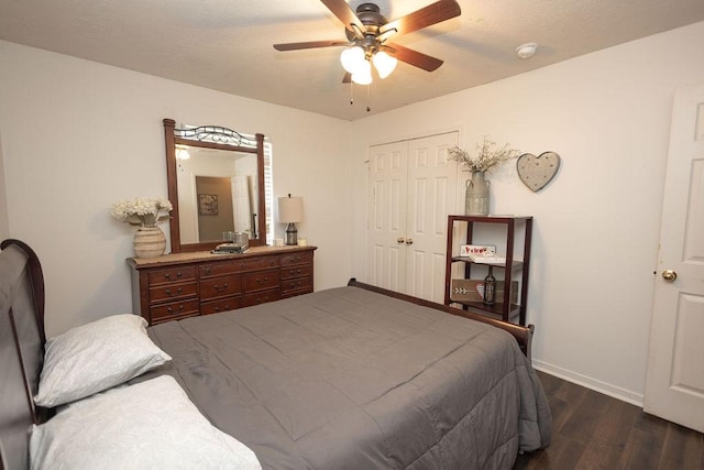 bedroom featuring ceiling fan, a closet, and dark wood-type flooring