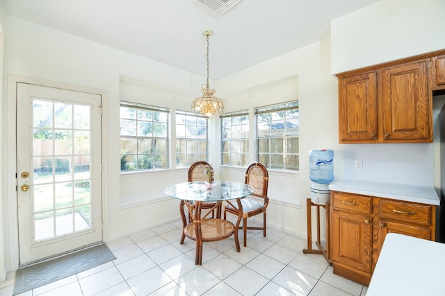 tiled dining space featuring an inviting chandelier