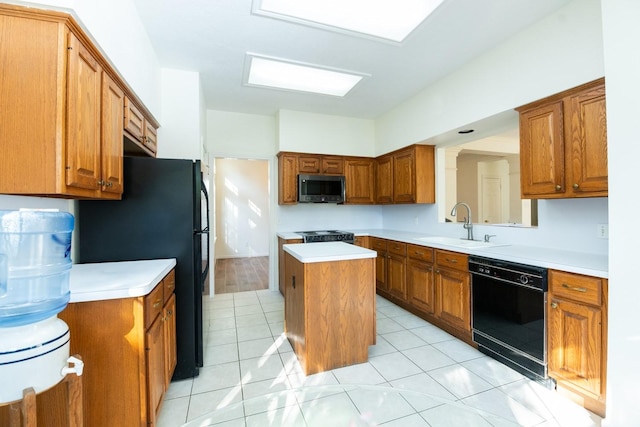 kitchen featuring black appliances, a center island, light tile patterned floors, and sink