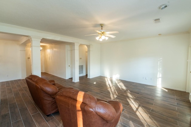 unfurnished living room with ceiling fan, ornamental molding, and ornate columns