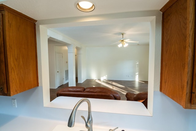 interior space with ceiling fan and ornamental molding