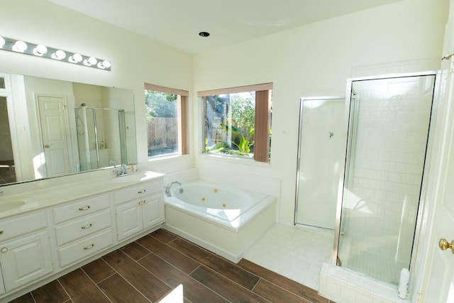 bathroom featuring vanity and shower with separate bathtub