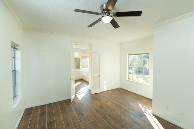 empty room featuring a textured ceiling, ceiling fan, and ornamental molding