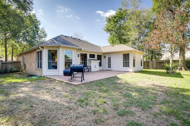 back of property featuring a lawn and a patio area