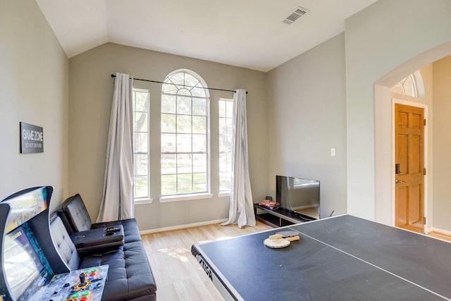 rec room featuring vaulted ceiling and light hardwood / wood-style flooring