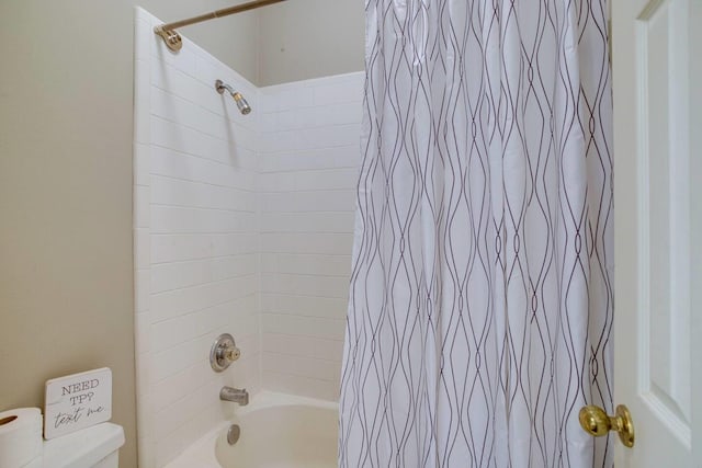 bathroom featuring shower / bath combination with curtain and toilet