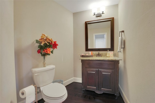 bathroom featuring hardwood / wood-style floors, vanity, and toilet