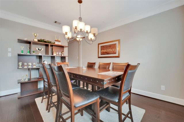 dining room with dark hardwood / wood-style flooring, crown molding, and an inviting chandelier