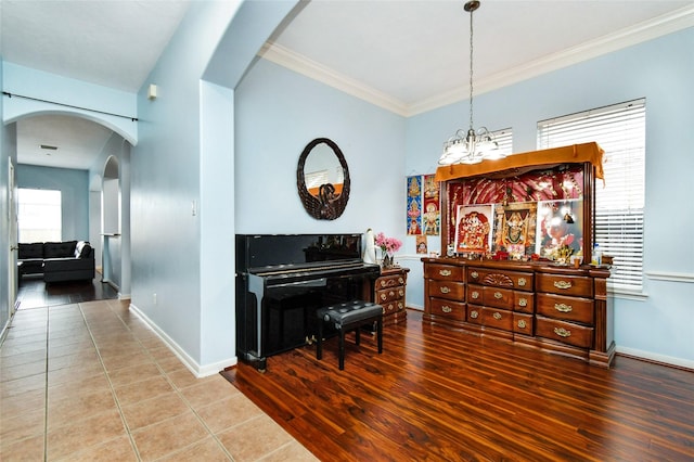 misc room featuring a chandelier, tile patterned floors, and ornamental molding