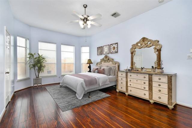 bedroom featuring multiple windows, ceiling fan, and dark wood-type flooring