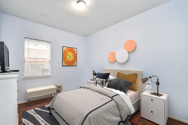 bedroom with dark wood-type flooring