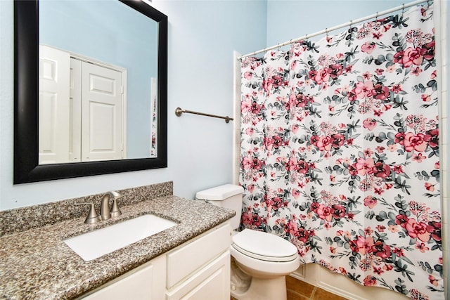 bathroom featuring tile patterned floors, toilet, vanity, and a shower with shower curtain