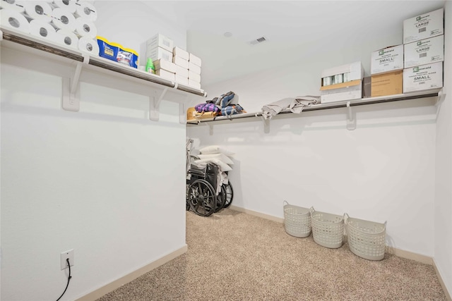 walk in closet with carpet flooring