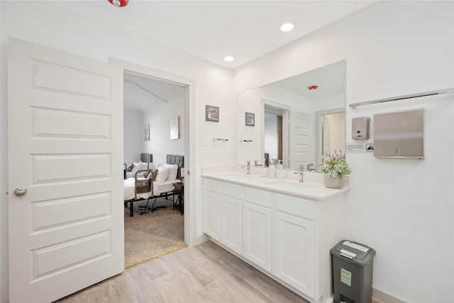 bathroom with hardwood / wood-style floors and vanity