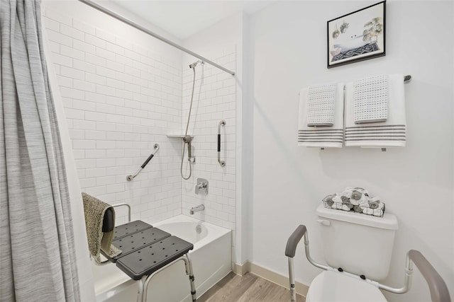 bathroom featuring toilet, wood-type flooring, and shower / tub combo