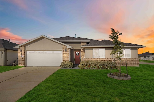 single story home featuring a lawn and a garage