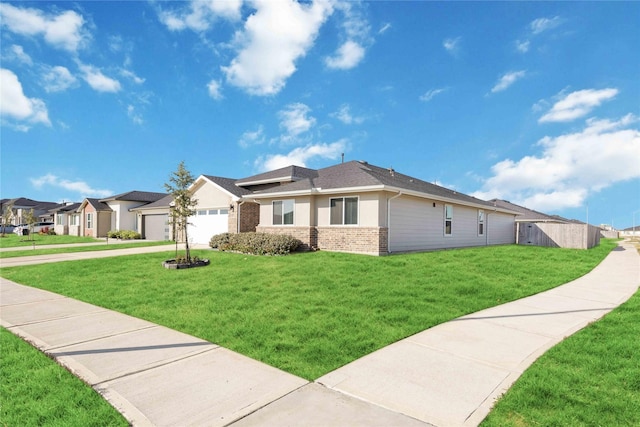 view of front of home featuring a front lawn and a garage