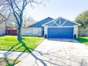 ranch-style home with a front yard and a garage