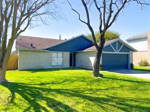 ranch-style home with a garage and a front yard