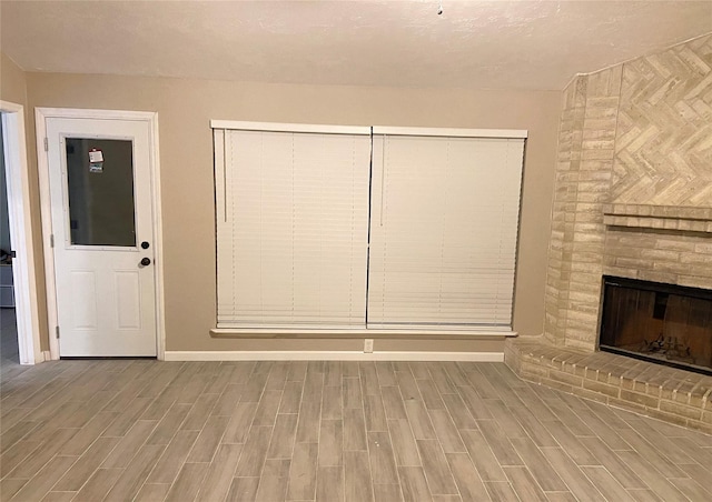 unfurnished living room with a brick fireplace