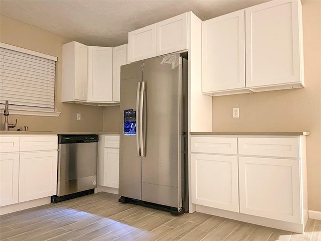 kitchen featuring white cabinetry, appliances with stainless steel finishes, and sink