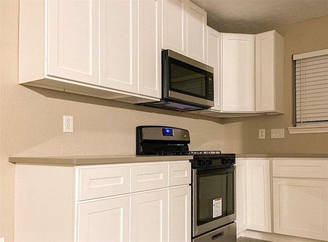 kitchen featuring appliances with stainless steel finishes and white cabinets