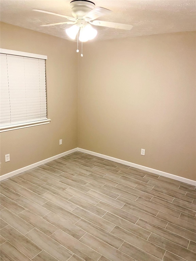 empty room featuring ceiling fan and a textured ceiling