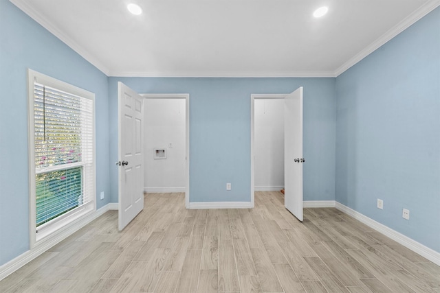 unfurnished bedroom with multiple windows, ornamental molding, and light wood-type flooring