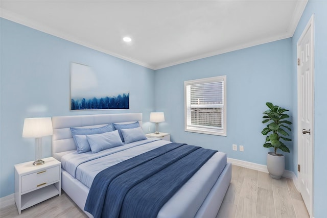 bedroom featuring light hardwood / wood-style floors and ornamental molding