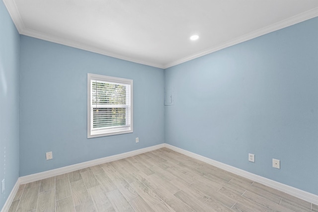 empty room with light wood-type flooring and ornamental molding