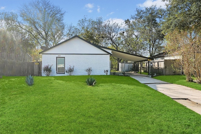 exterior space featuring a lawn and a carport