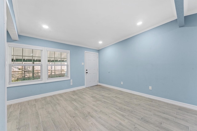 unfurnished room featuring light hardwood / wood-style flooring, beamed ceiling, and ornamental molding