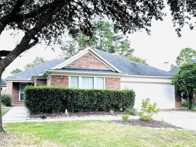 view of front facade with a front yard and a garage