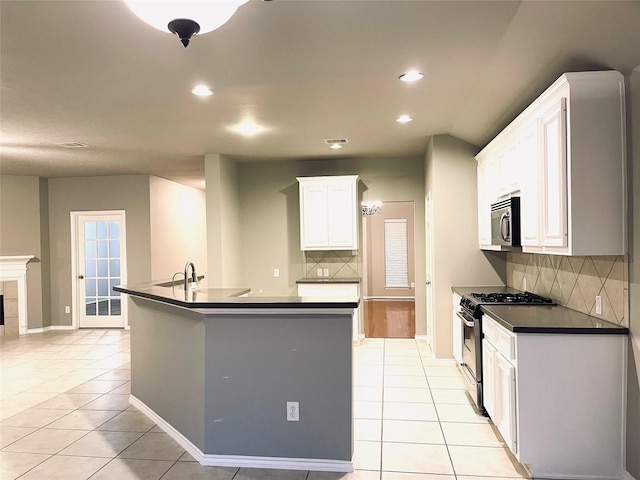 kitchen featuring backsplash, white cabinetry, light tile patterned floors, and stainless steel appliances